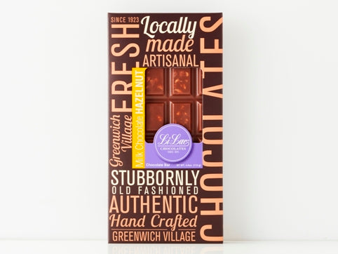A handsome brown box with a bold graphic design and a window showing through to the chocolate bar