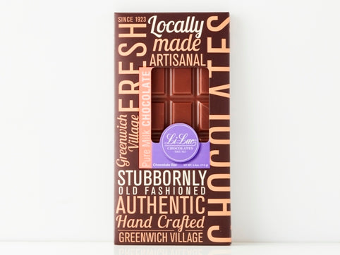 A handsome brown box with a bold graphic design and a window showing through to the chocolate bar