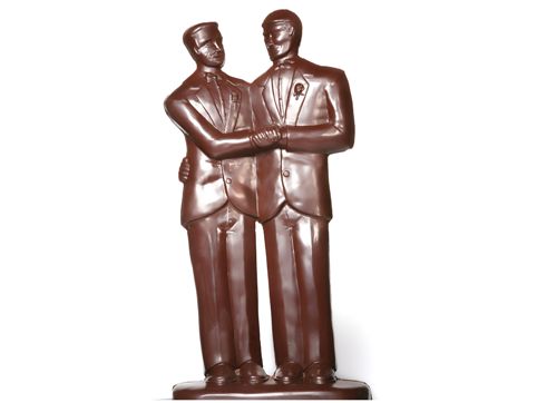 Two molded chocolate Grooms stand side by side in smart suits.