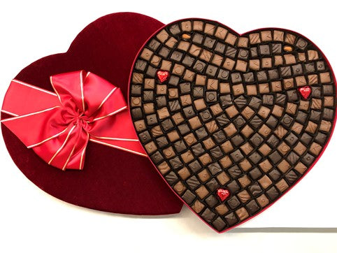A oversized giant heart is filled with two hundred and ten assorted chocolates.