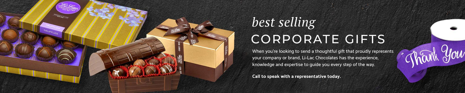 a bold black leather background with two handsome boxes of truffles and a roll of purple ribbon that says thank you.