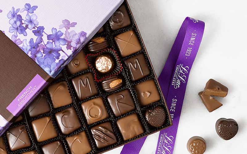 A box of chocolate with the cover partially open