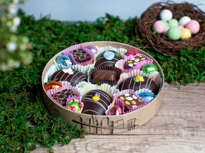 A open box filled with 17 festive Easter chocolates.