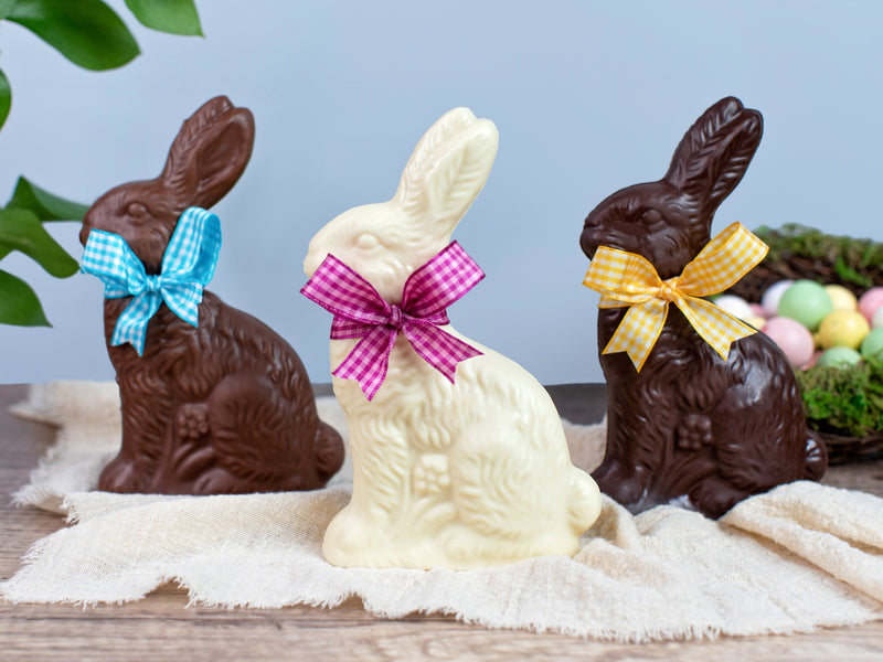 three chocolate bunnies with Easter bows around their necks