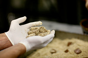 two hands wearing white gloves holding butter crunch