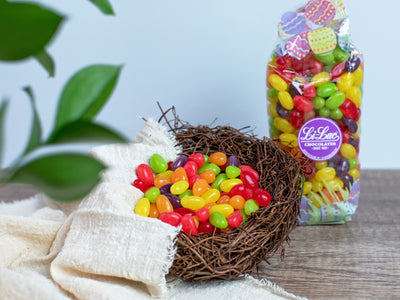 Colorful Jelly Beans in a bird's next with a bag of Jelly Beans behind it. 