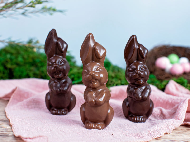 three chocolate bunnies showing their front teeth as they laugh.
