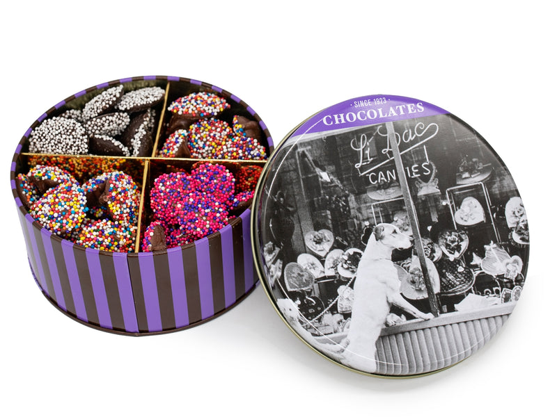 A round tin with a vintage photo of the original Li-Lac storefront window on the cover, filled with colorful chocolate Nonpareils