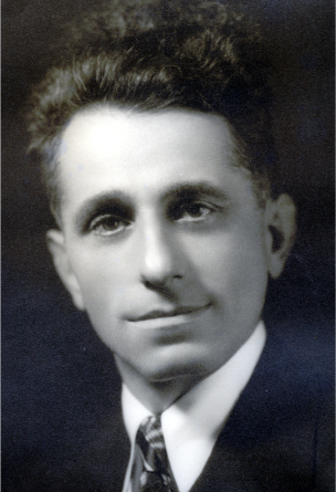 Black and white photo of Mr. Demetrious, a white man wearing a collared shirt and tie