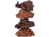 An artful stack of four milk and dark coconut clusters.