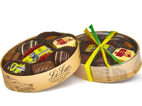 8 piece oval shaped box tied with raffia. It has assorted NYC themed chocolates and a yellow chocolate taxi in the center