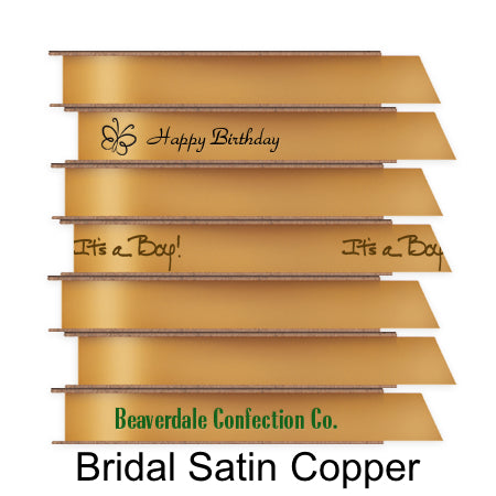 A stack of seven spools of shiny coppery orange satin ribbon with custom messages printed on them in different colors. 