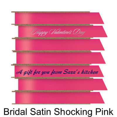 A stack of seven spools of shiny bright pink satin ribbon with custom messages printed on them in different colors. 
