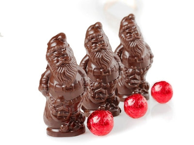 Little tiny chocolate molded Santa Claus and a foil wrapped chocolate ball.