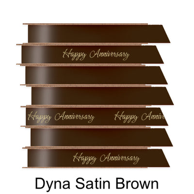 A stack of seven spools of shiny brown satin ribbon with custom messages printed on them in different colors. 
