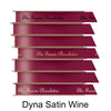 A stack of seven spools of shiny wine satin ribbon with custom messages printed on them in different colors. 