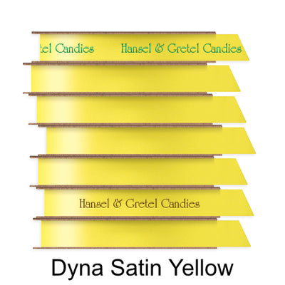 A stack of seven spools of shiny bright yellow satin ribbon with custom messages printed on them in different colors. 
