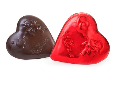Molded chocolate heart is wrapped in bright red foil.