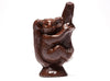 A cute little molded chocolate Koala Bear sits in the branches of a tree.