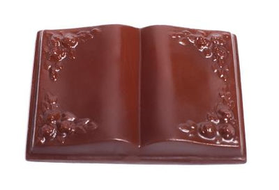 A chocolate molded Bible or book, open, showing filagree on the corners of the pages.