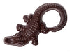 A dark chocolate molded alligator with a long, curved tail.