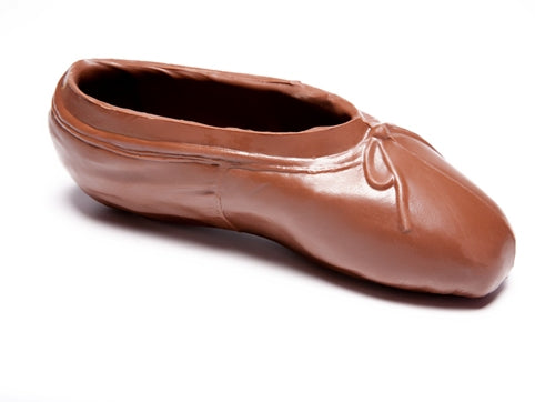 Milk chocolate molded into the shape of a three-dimensional ballet slipper.