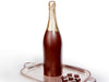 A large, magnumm sized dark chocolate champagne bottle stands on a silver platter. The bottle has a gold foiled top to look like a real bottle of champagne.