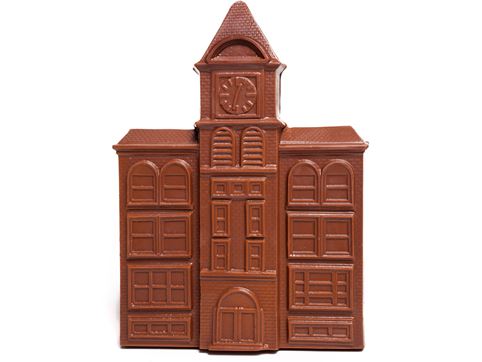 A chocolate molded city hall building with a bell tower.