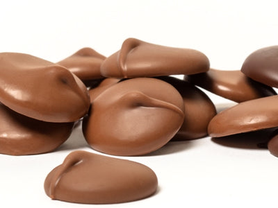 Small dollops of milk chocolate sit together.