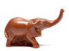 A small chocolate elephant with a raised trunk.