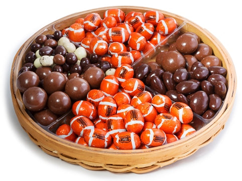Malt balls, chocolate covered almonds, espresso mix and chocolates wrapped in foil to look like footballs are artfully placed on a platter.