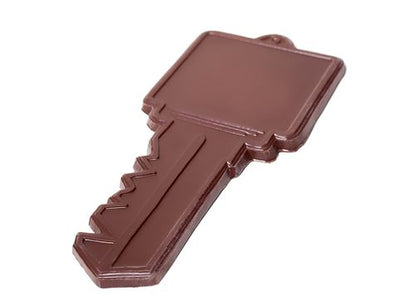 A large square headed chocolate molded key, complete with cuts in the blade.