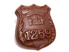 A chocolate molded Police Badge with number 1259 embossed onto it.