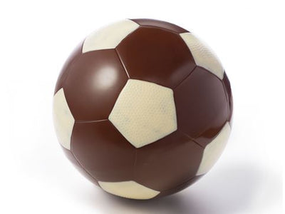 A life sized molded chocolate Soccer Ball has some hexagons painted in white chocolate on dark chocolate.