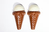 two tiny chocolate molded Ice Cream Cones have white chocolate 'vanilla' scoops in them.