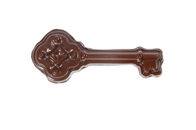 A molded chocolate antique filagreed headed key, complete with cuts in the blade.
