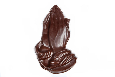 Three-dimensional chocolate molded praying hands