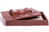 A three-dimensional chocolate molded rectangular box with ribbon detailing. The lid can be removed.
