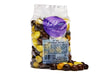 A cellophane bag of  a mix of yellow and brown enrobed espresso beans..