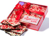 Slabs of Chocolate Peppermint Bark sit in a festive red holiday box.