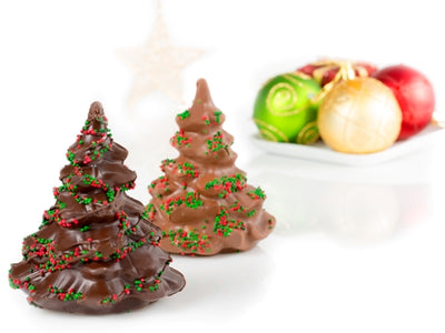 A small chocolate molded evergreen tree with nonpareil candies on the tree boughs in red and green.