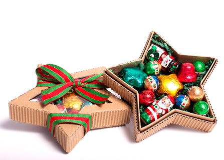 A star shaped box made out of brown kraft paper has brightly colored foil wrapped chocolates inside. 