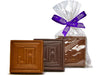 Chocolate square molded with your custom logo in the center. One is wrapped in a cello bag with a ribbon tie.