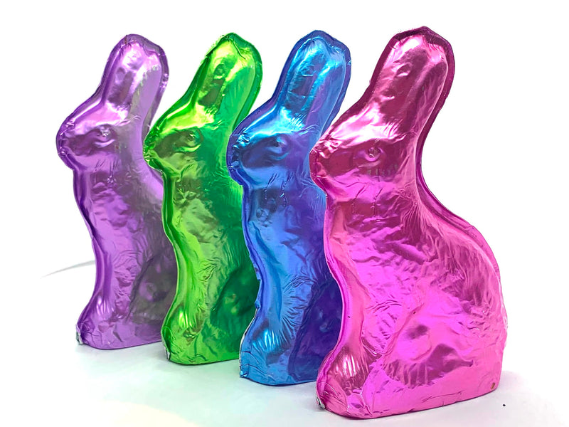 Molded chocolate bunnies are wrapped in pink, blue, green or purple foil.
