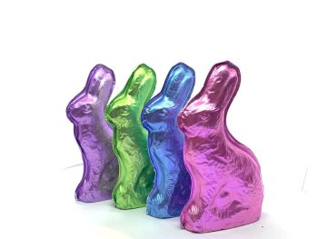 Chocolate molded bunnies are wrapped in pink, green, blue or purple foil.