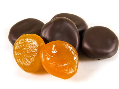 Pieces of candied, glace apricots, enrobed in dark chocolate sit together.