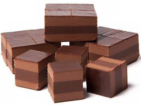 Stacked squares of layered milk and dark chocolate soft hazelnut ganache sit together.