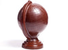 A three dimensional molded chocolate globe on a stand.