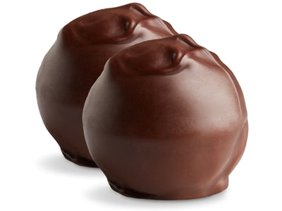 Two french cream truffles sit side by side. They are enrobed in dark chocolate with dark chocolate swirl pattern on top. 