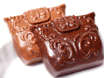 Little chocolate molded handbags with a clutch handle.